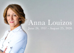 Alt Text: ``` Scenic designer Anna Louizos in a white shirt, with her name and the dates June 24, 1957 – August 25, 2026